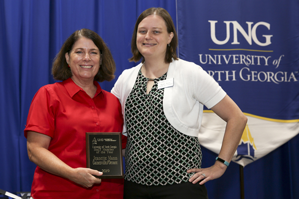 Jeanette Mann holds Staff member of the Year Award