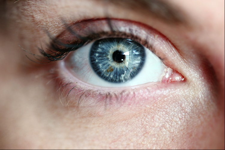 Close-ip image of a woman's eye looking straight ahead.