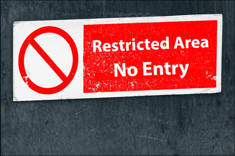 Restricted Area, No Entry sign on a wall